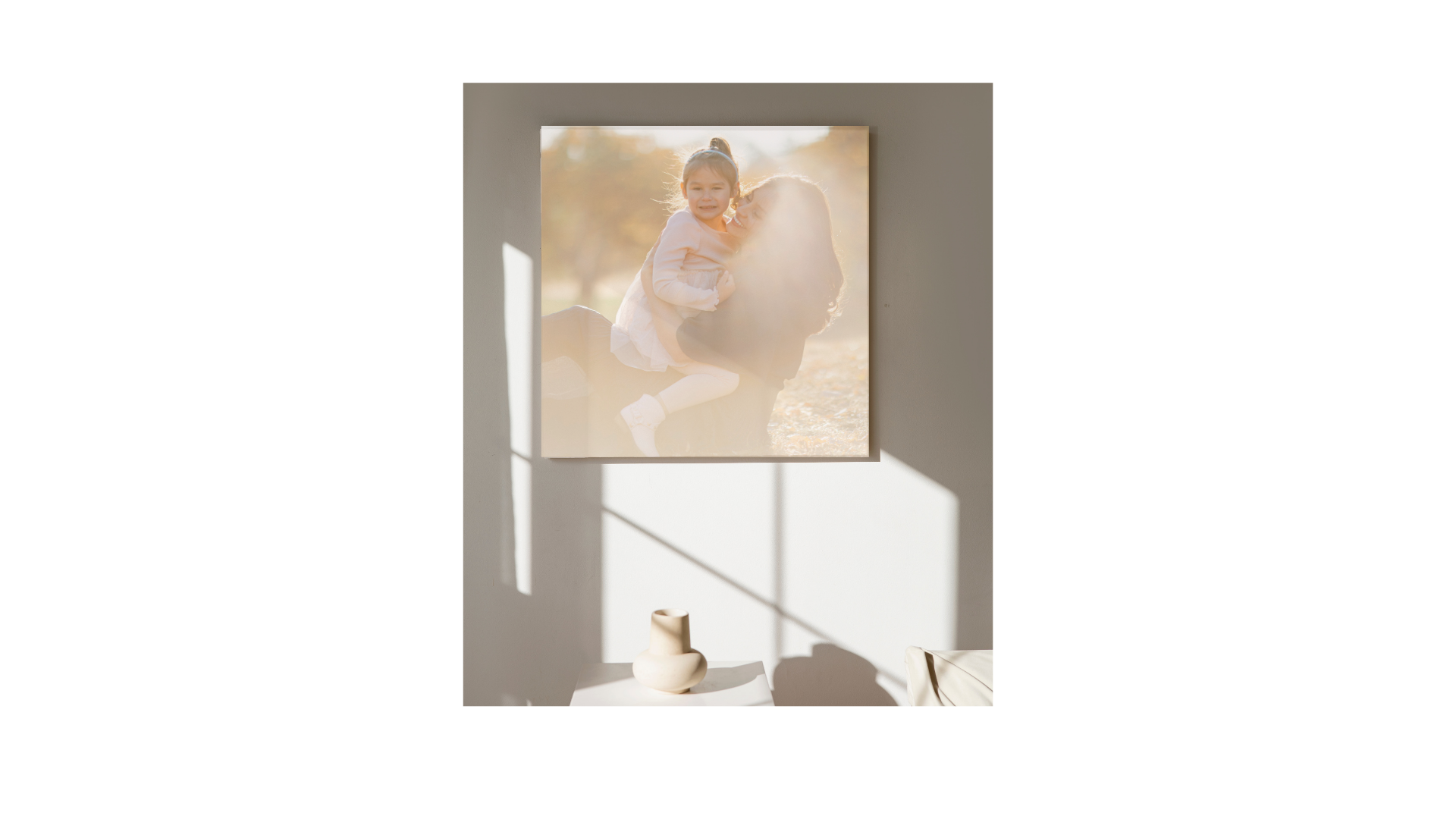 A framed art print on a neutral wall creating dramatic shadows in natural light.