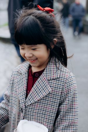 Cotswolds family photographer capturing portraits by the river in Bourton-on-the-Water.