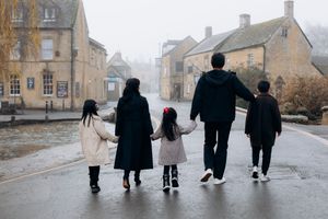 Cotswolds family photographer capturing portraits by the river in Bourton-on-the-Water.