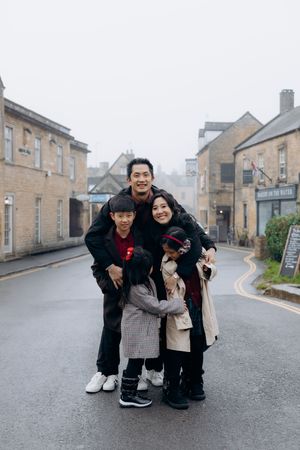 Cotswolds family photographer capturing portraits by the river in Bourton-on-the-Water.