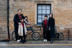 Cotswolds family photographer capturing portraits by the river in Bourton-on-the-Water.