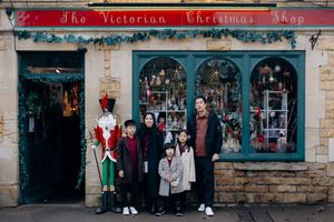 Cotswolds family photographer capturing portraits by the river in Bourton-on-the-Water.