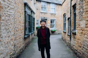 Cotswolds family photographer capturing portraits by the river in Bourton-on-the-Water.