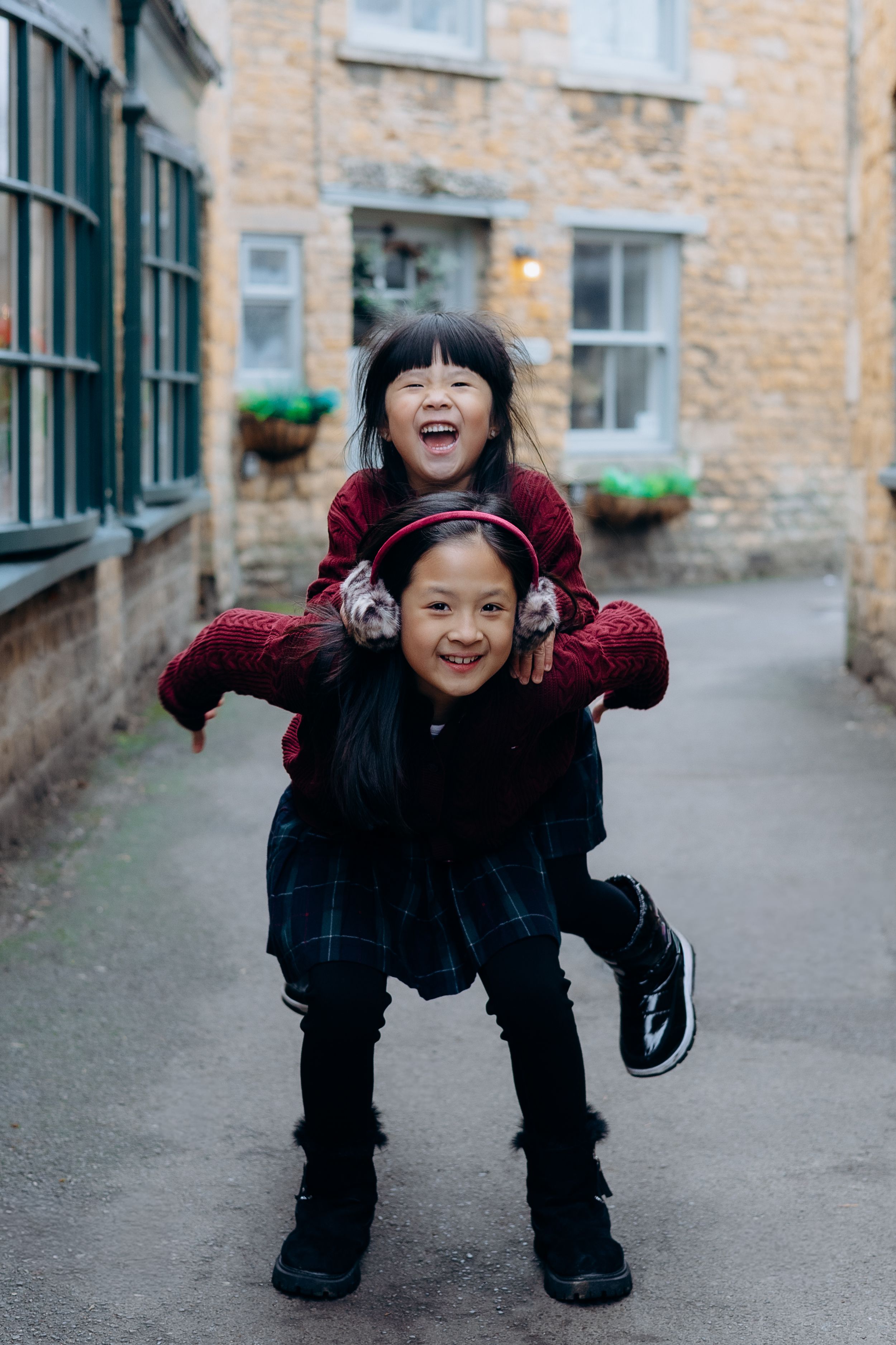 Cotswolds family photographer capturing portraits by the river in Bourton-on-the-Water.