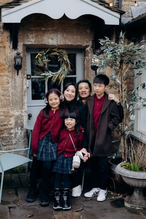 Cotswolds family photographer capturing portraits by the river in Bourton-on-the-Water.