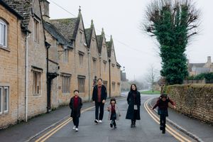 Cotswolds family photographer capturing portraits by the river in Bourton-on-the-Water.