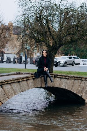 Cotswolds family photographer capturing portraits by the river in Bourton-on-the-Water.