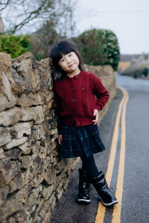 Cotswolds family photographer capturing portraits by the river in Bourton-on-the-Water.