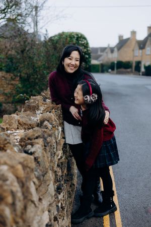 Cotswolds family photographer capturing portraits by the river in Bourton-on-the-Water.
