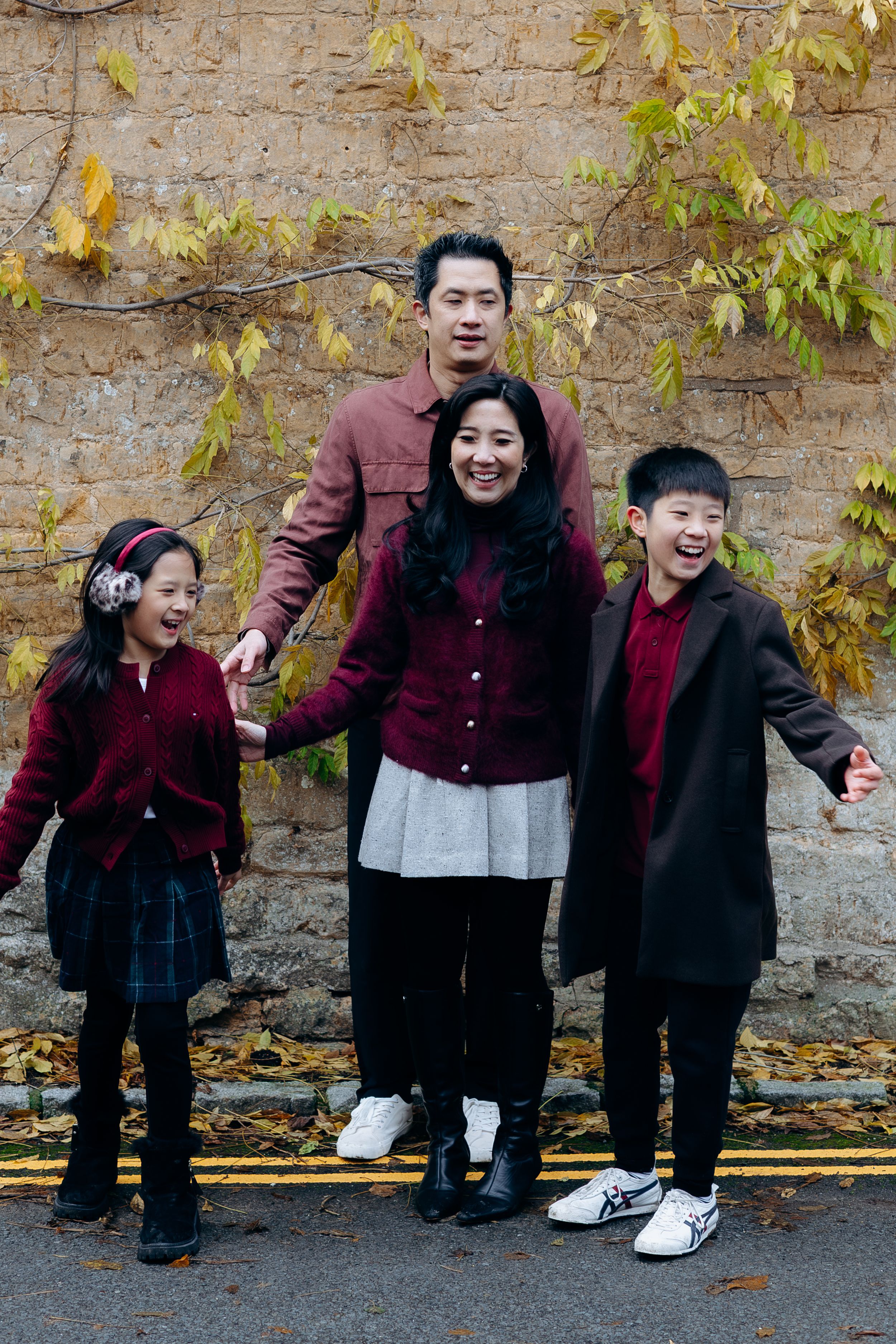 Cotswolds family photographer capturing portraits by the river in Bourton-on-the-Water.