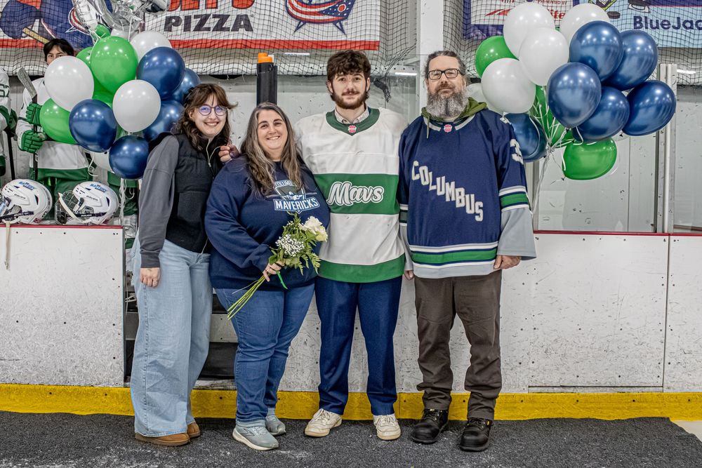 Hockey celebration event with balloons and decorations at ice rink entrance.