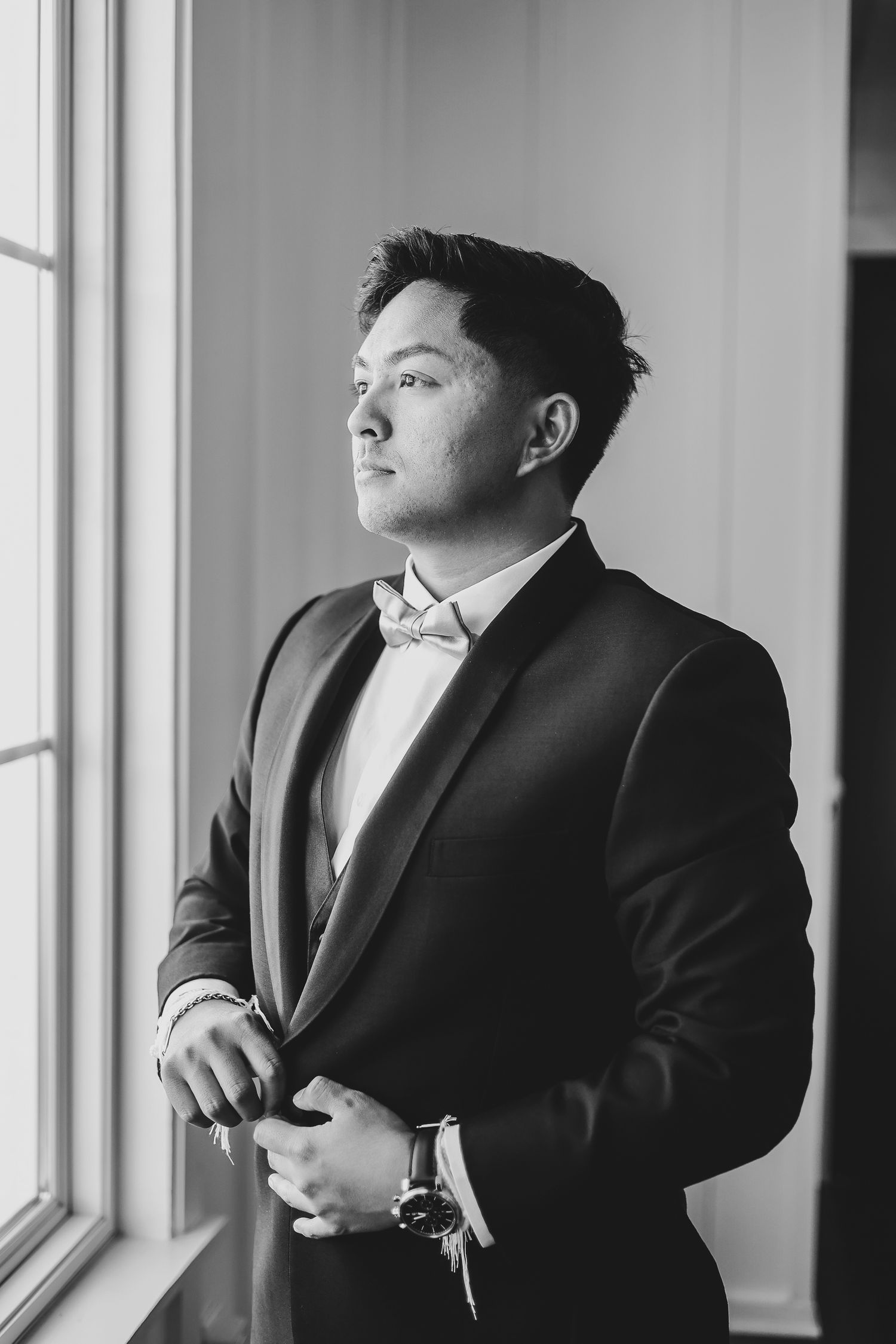 Groom portrait in black tuxedo captured in natural light at Firefly Gardens wedding venue