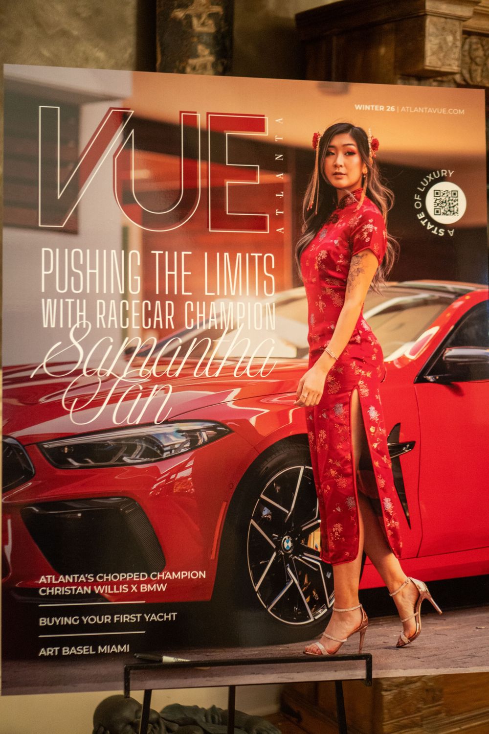 Magazine cover featuring a red qipao dress against a red sports car with VUE magazine title and text about pushing limits.