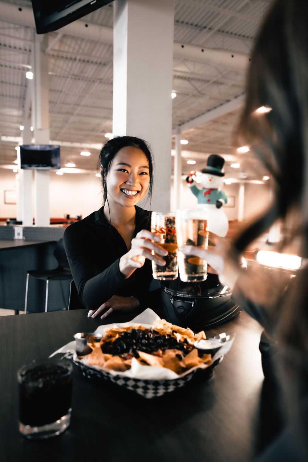 Person enjoying drinks and food at a casual dining venue. Mtlshutter photography