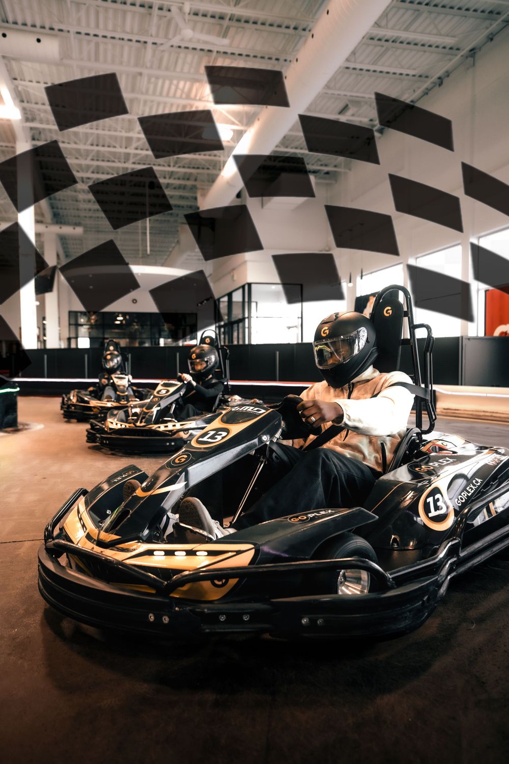 Go-kart racing track with checkered pattern ceiling and karts lined up ready for racing. Mtlshutter photography