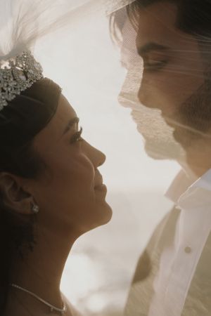 Atmospheric backlit wedding portraits with romantic silhouettes and soft lighting.