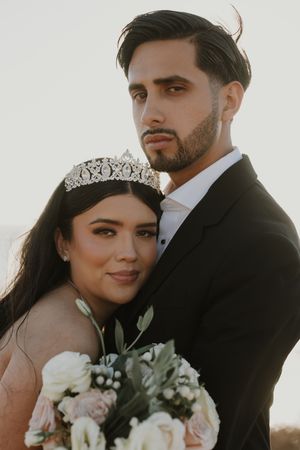 Intimate wedding portraits captured in soft natural lighting against white background.