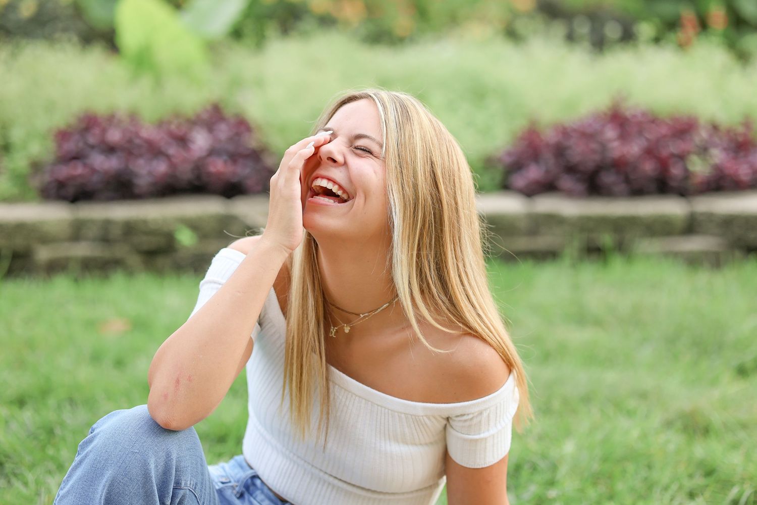 Central Illinois photographer captures a genuine smile and laugh during a senior session in Springfield, IL