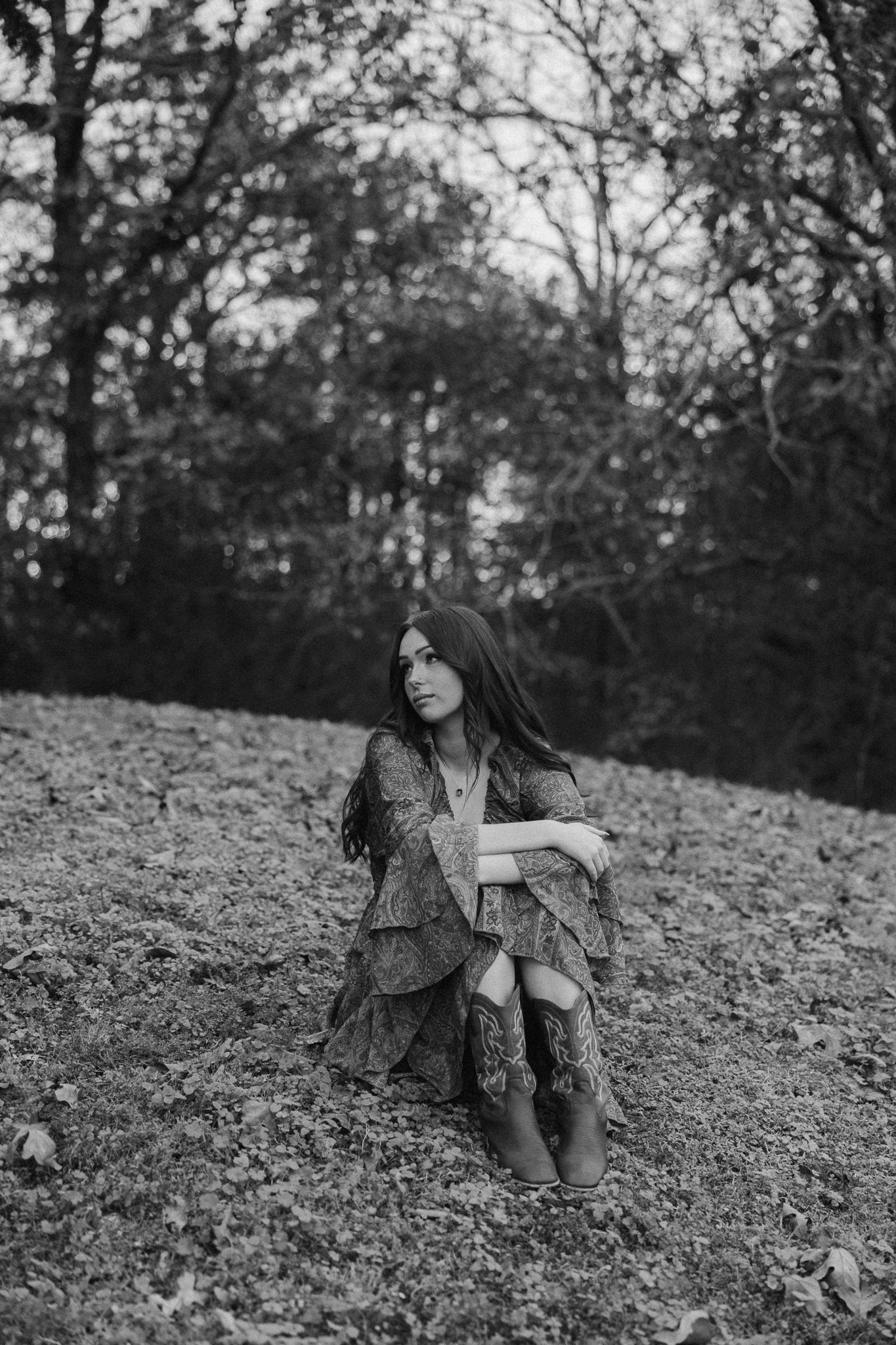 Black and white artistic portrait series showing movement and poses in a natural outdoor setting.