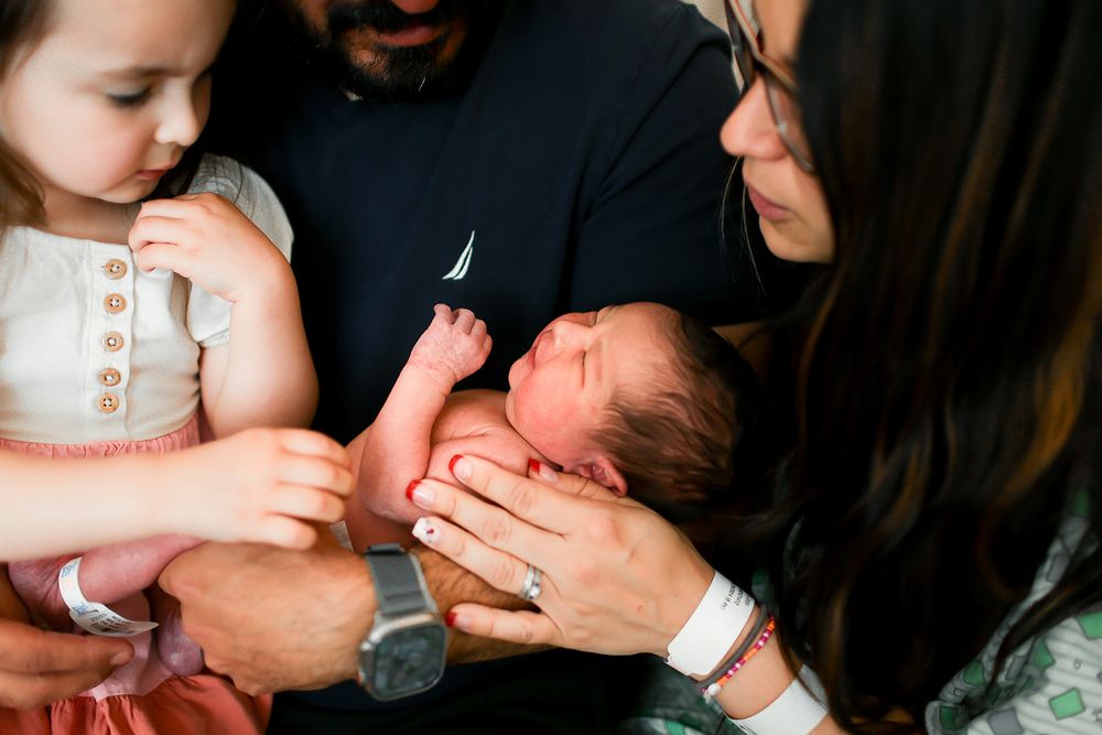 All family snuggling baby close