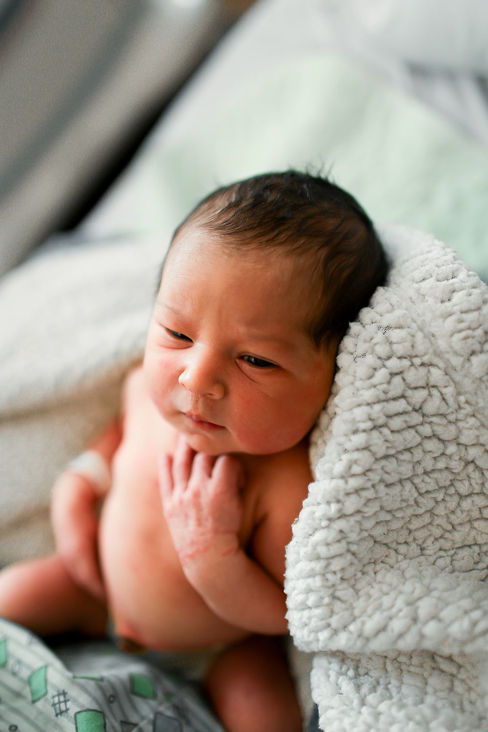 newborn baby girl snuggled ini blanket for fresh 48 session