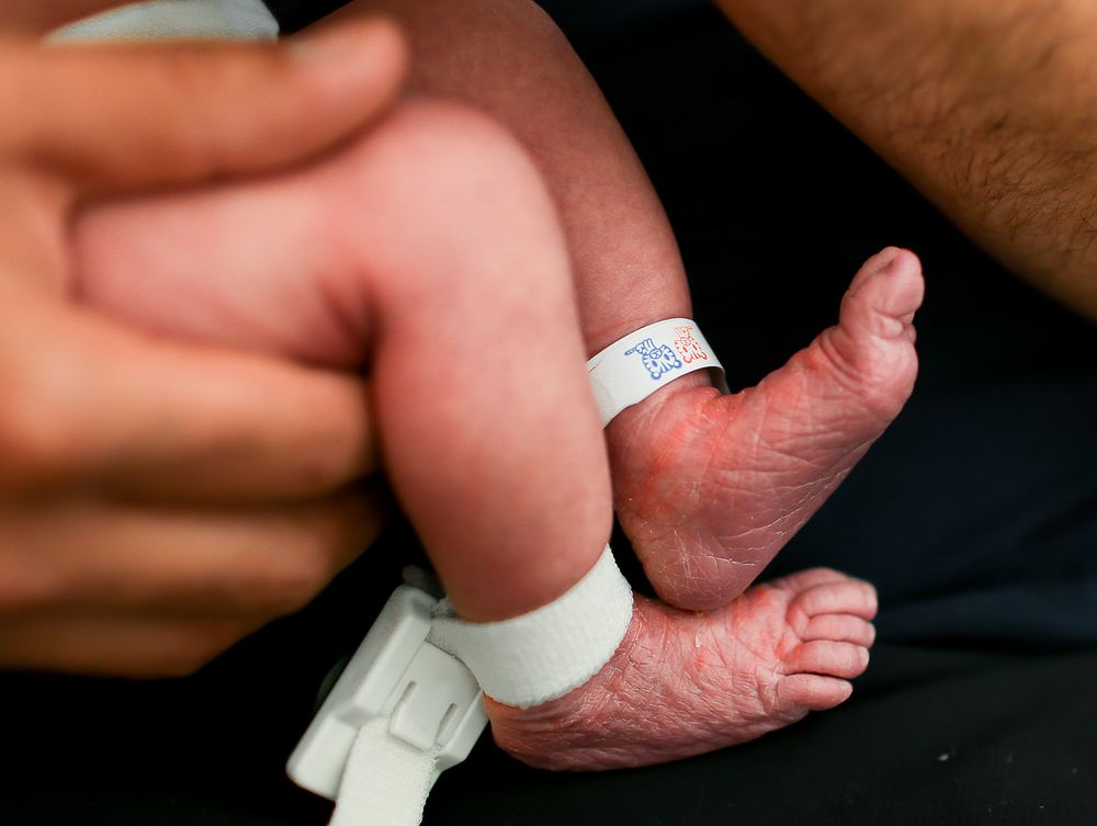 Newborn baby feet with hospital tag on ankles for fresh 48 session