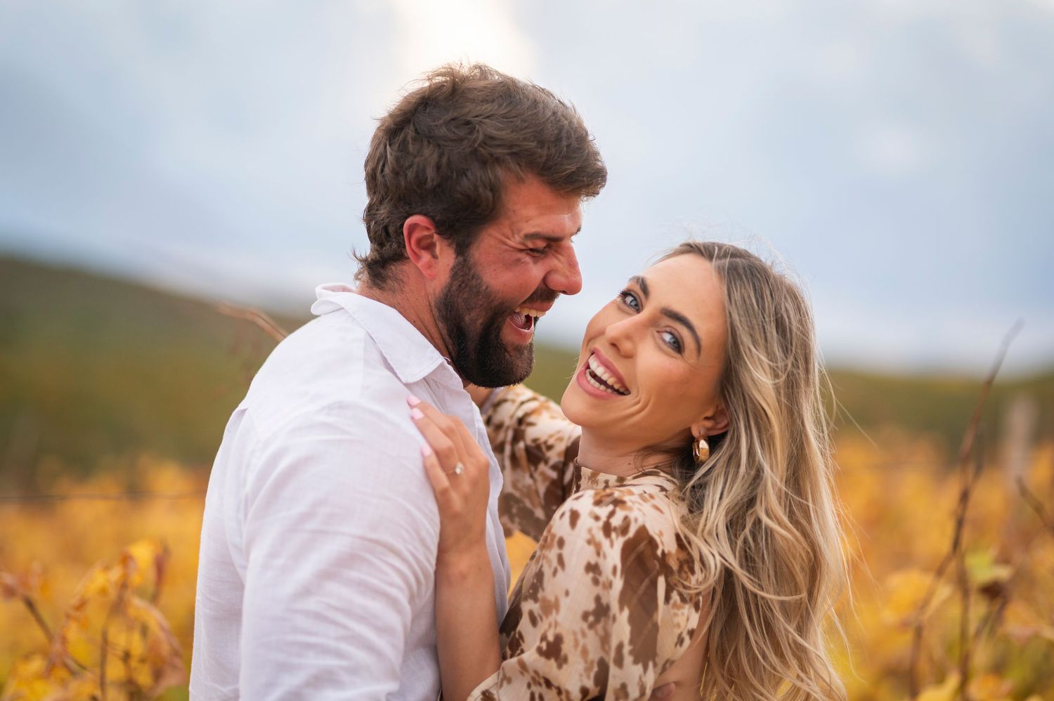 Couple shares loving moments in a golden field during sunset, with multiple candid shots showing their joyful interaction.
