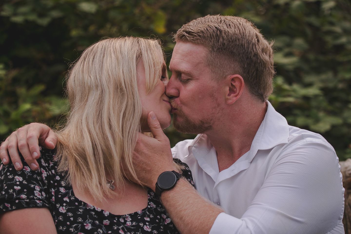 A couple share a kiss to celebrate their engagement by Poole, Bournemouth and Dorset wedding photographer "kris the photographer"