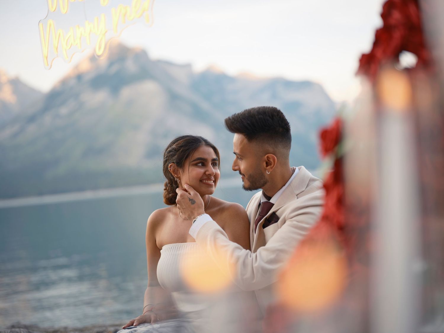 Dreamy mountain lake wedding photography shows couple sharing romantic moments against dramatic alpine backdrop for a Banff elopement
