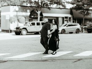 Black and white photo of couple walking together on a city street in Detroit Michigan.
