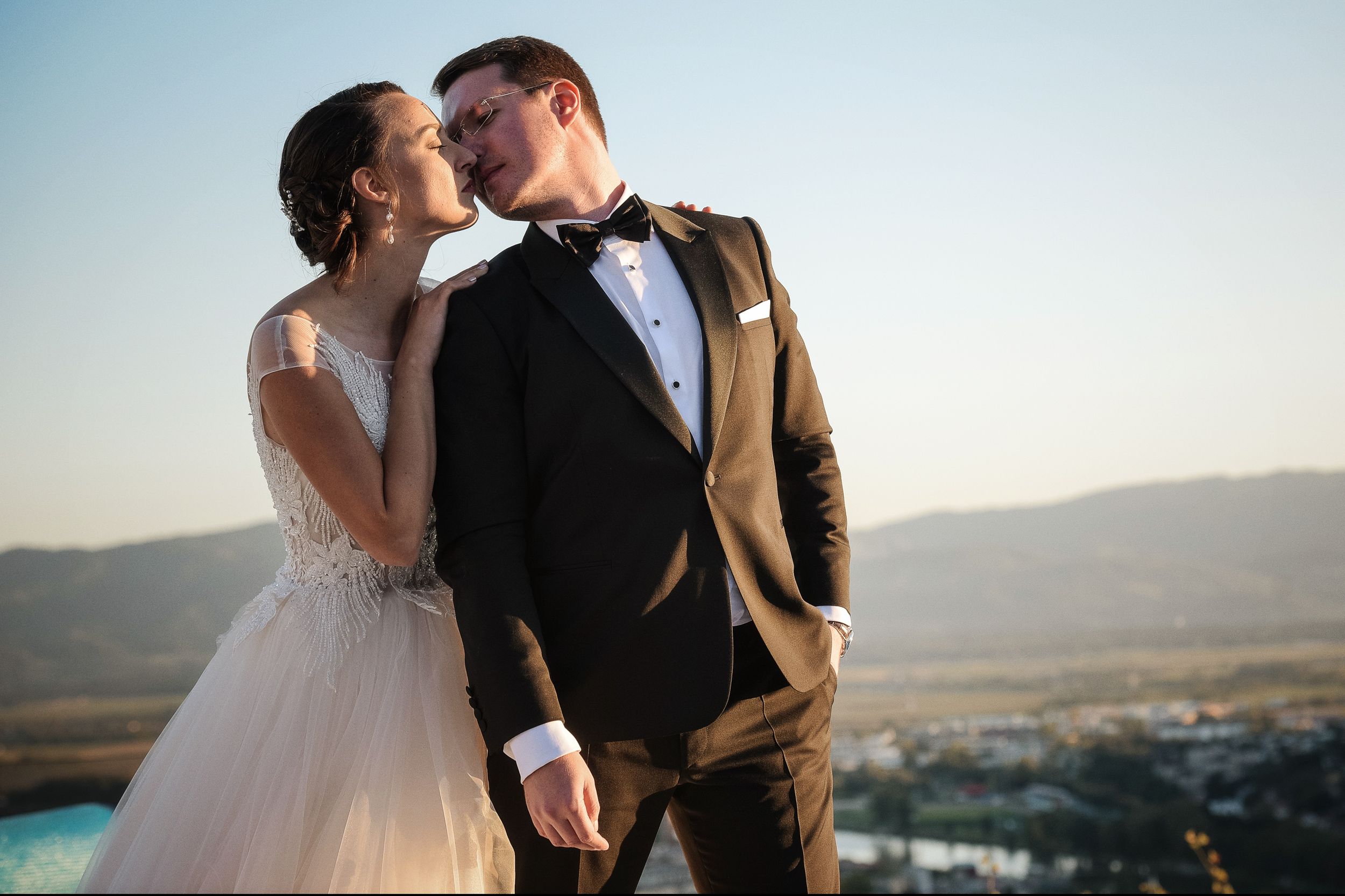 Intimate wedding portrait against mountain landscape at dusk. Restavracija Tri Lučke, Krško