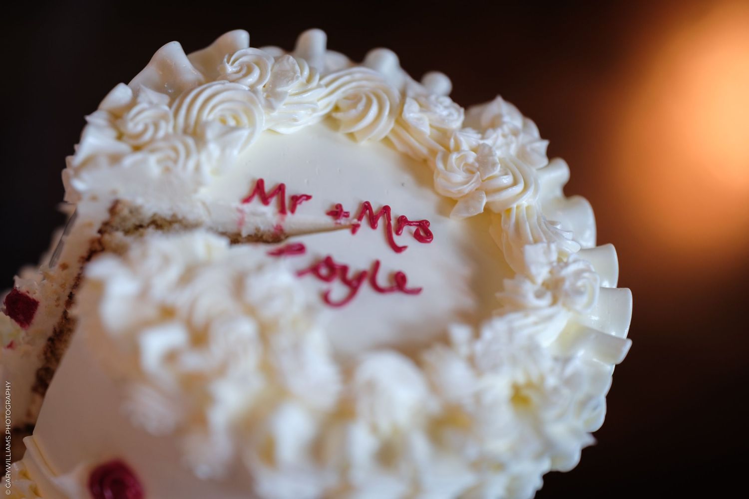A collage of white frosted wedding cake details with decorative piping and personalized text in pink lettering.