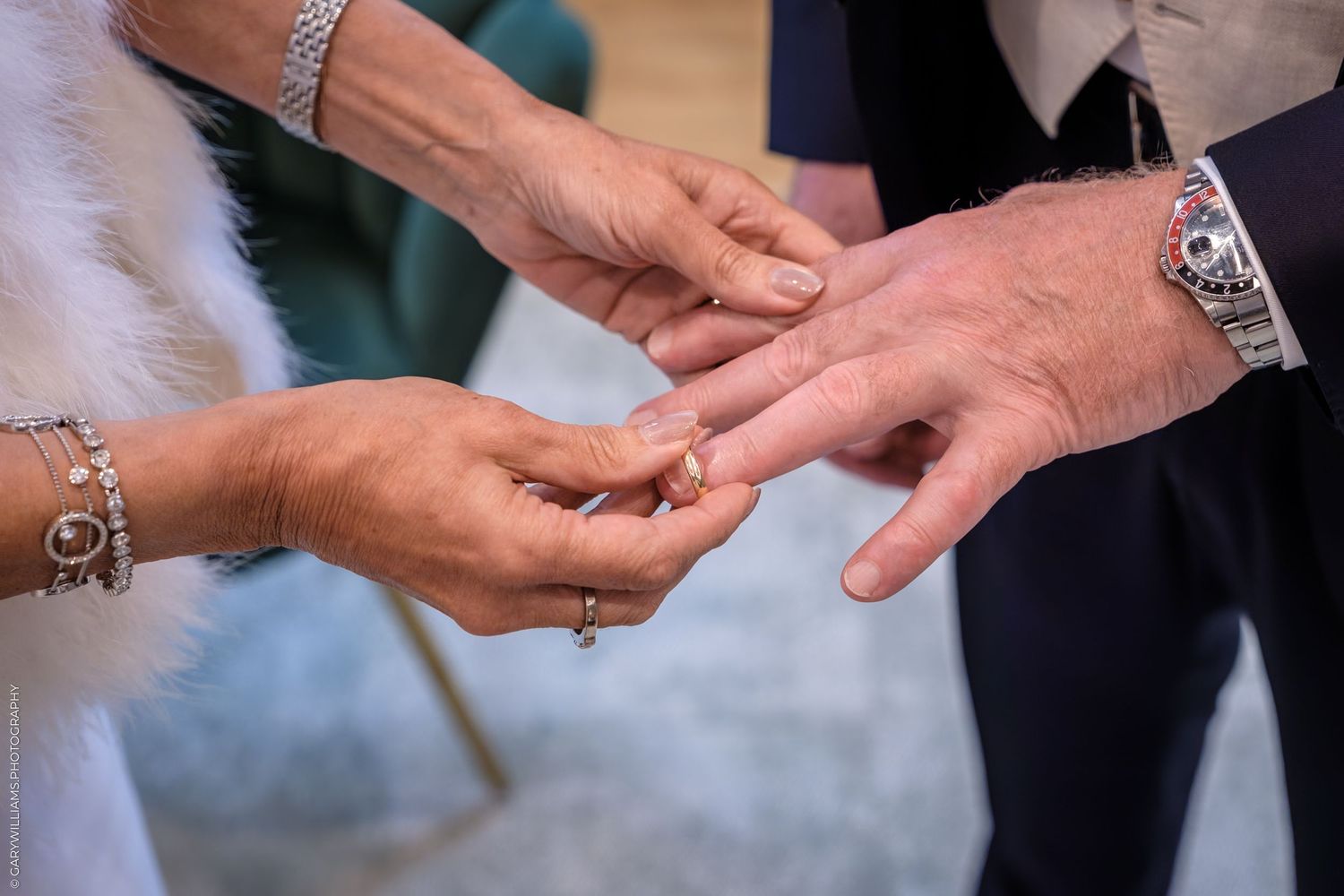 A series of close-up shots showing hands exchanging wedding rings during a marriage ceremony.