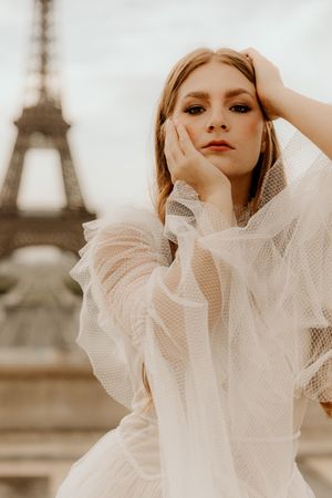 Romantic Paris photoshoot with delicate tulle gown and Eiffel Tower creating a soft, sepia-toned atmosphere.