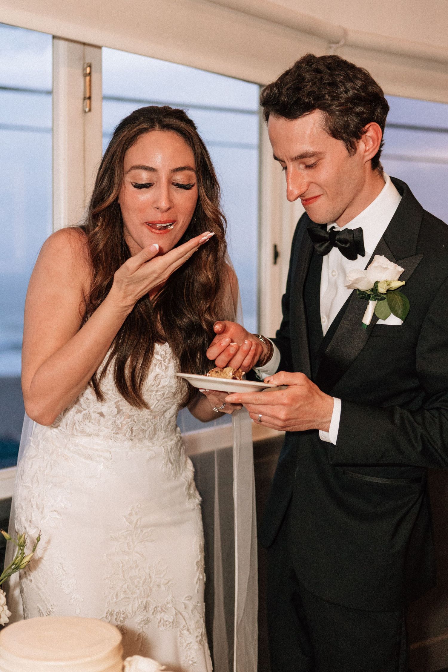 Romantic cake cutting at The Sunset Restaurant captured by a Malibu film photographer.