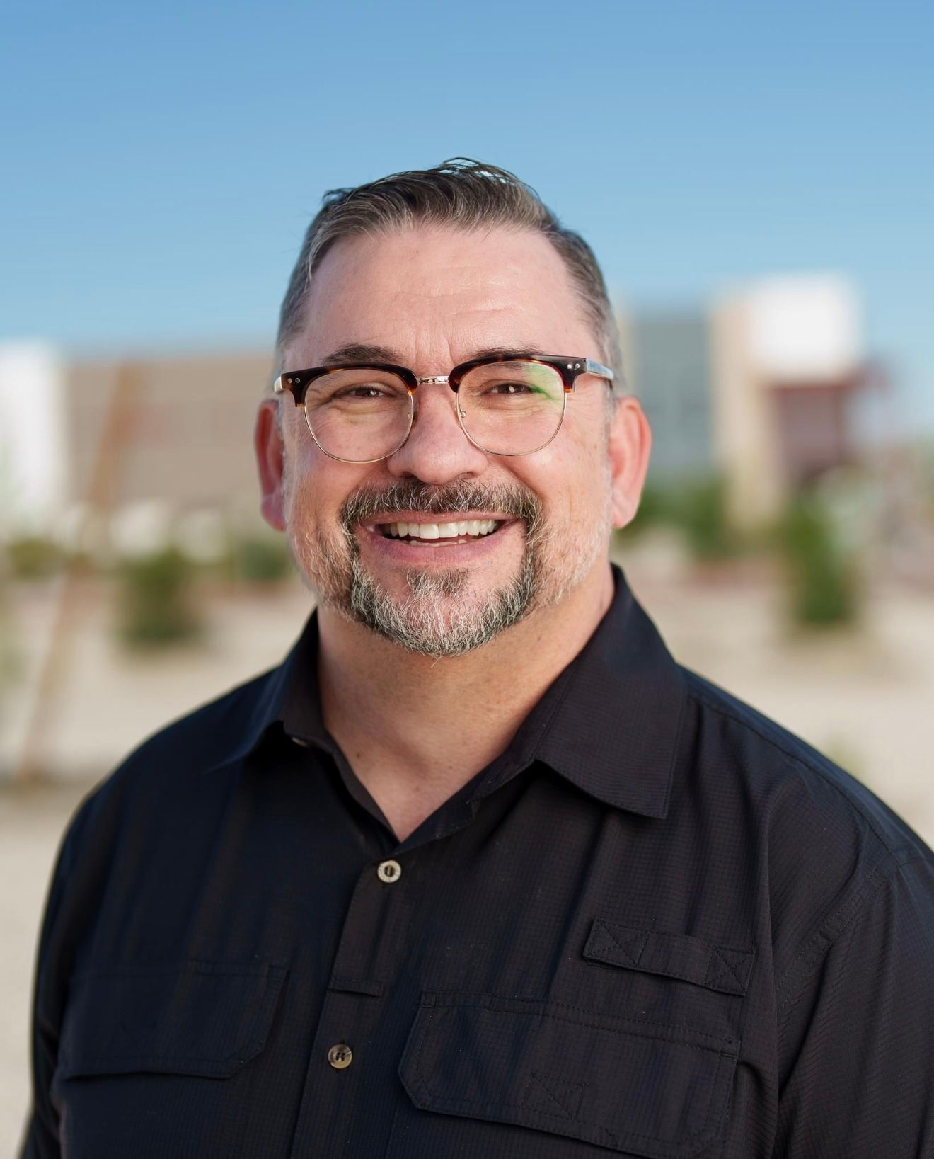 Series of professional headshots showing man in black shirt against outdoor background.