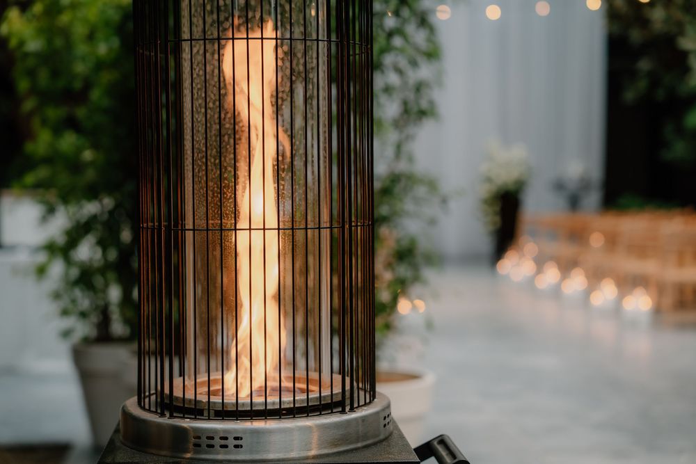 Decorative lantern with glass panels and illuminated candle creating warm ambiance at outdoor event.