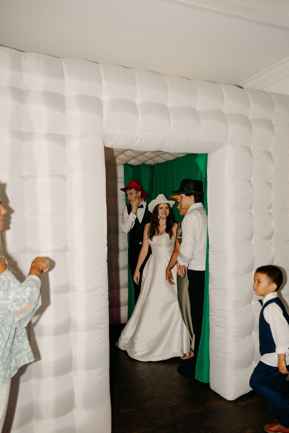 White inflatable walls create a unique photo backdrop at a wedding reception.