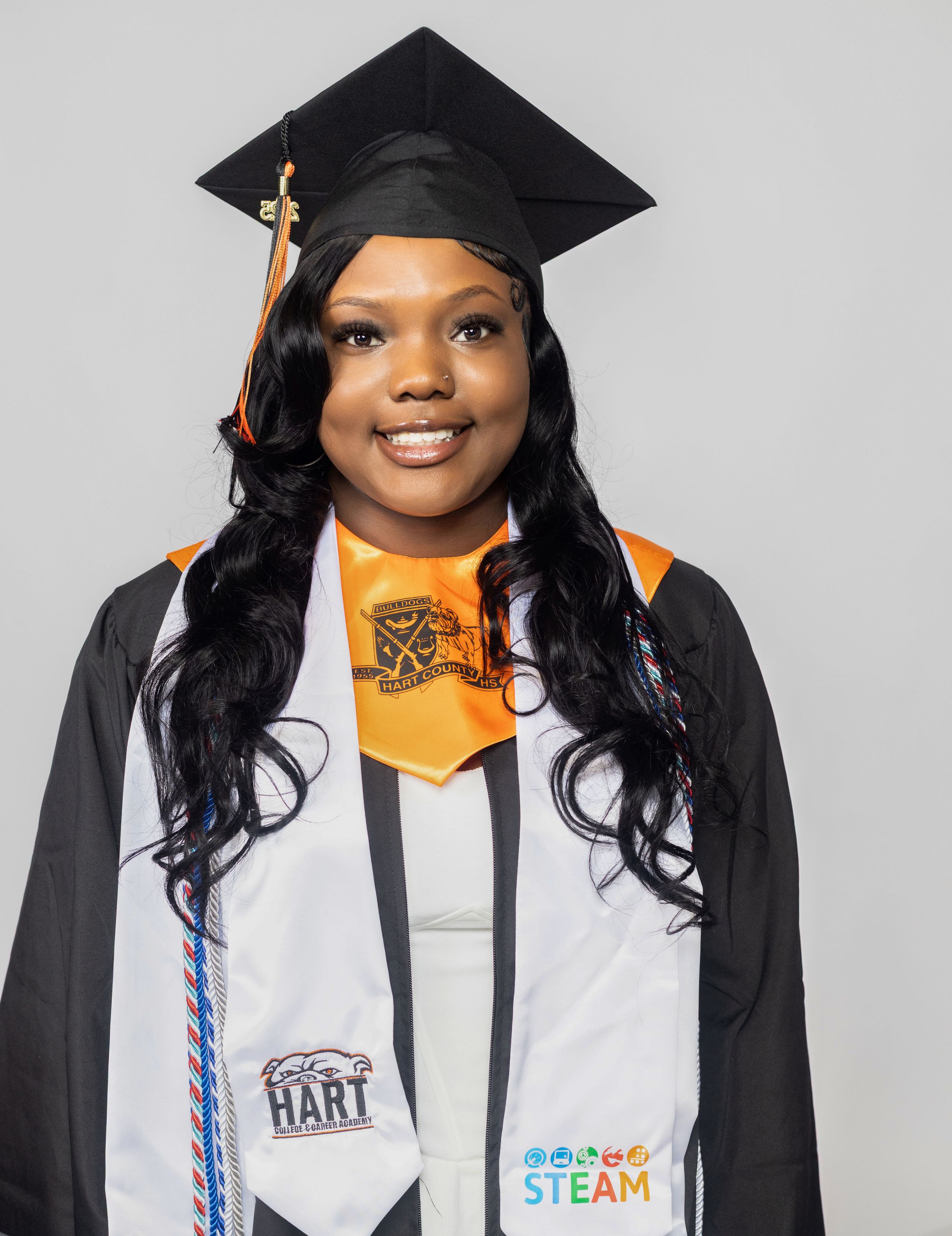 Graduation photos showing academic regalia with orange and black accents against grey background.