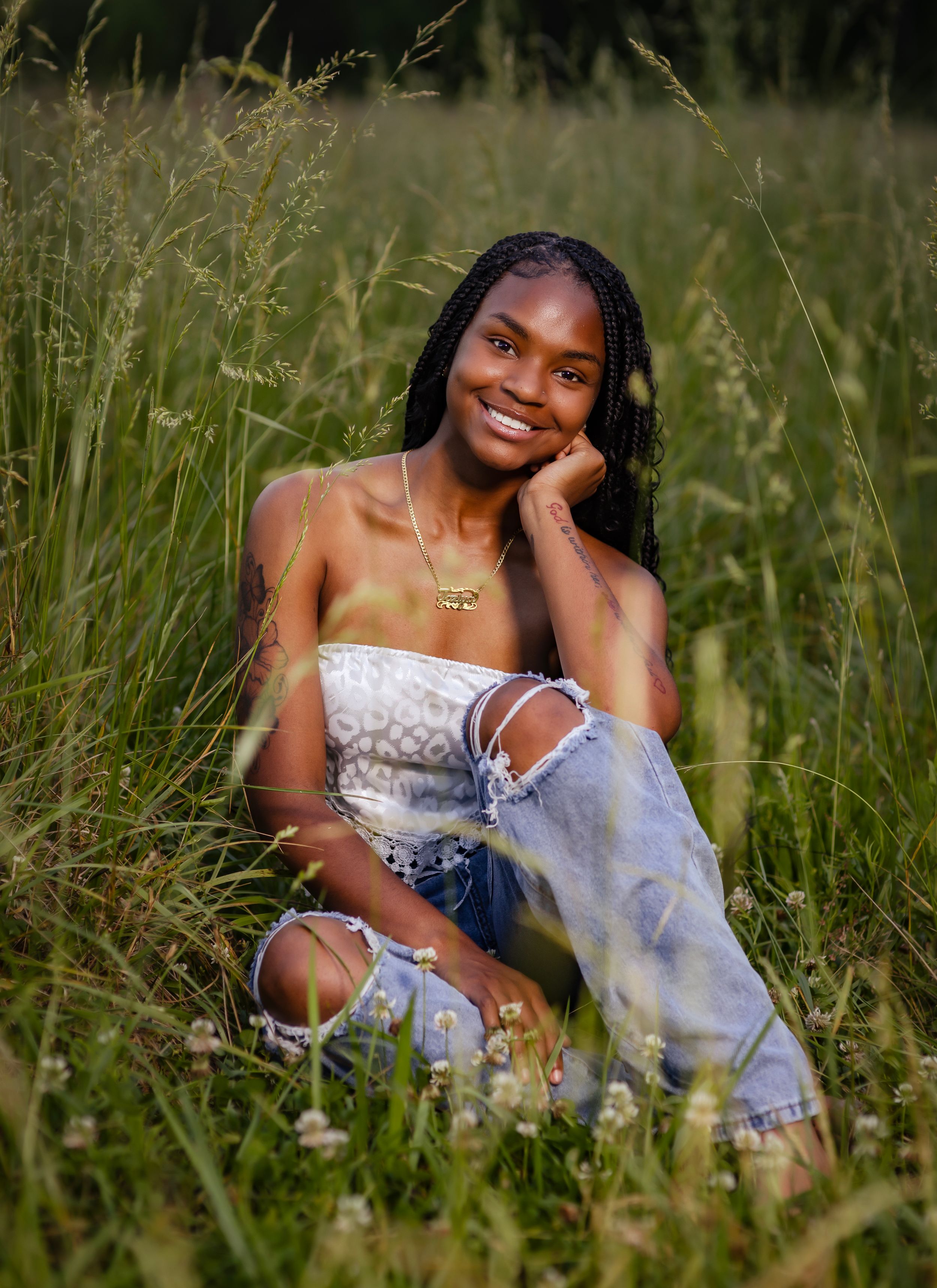 A white sundress photoshoot in tall grass during golden hour showing joyful poses and natural scenery.