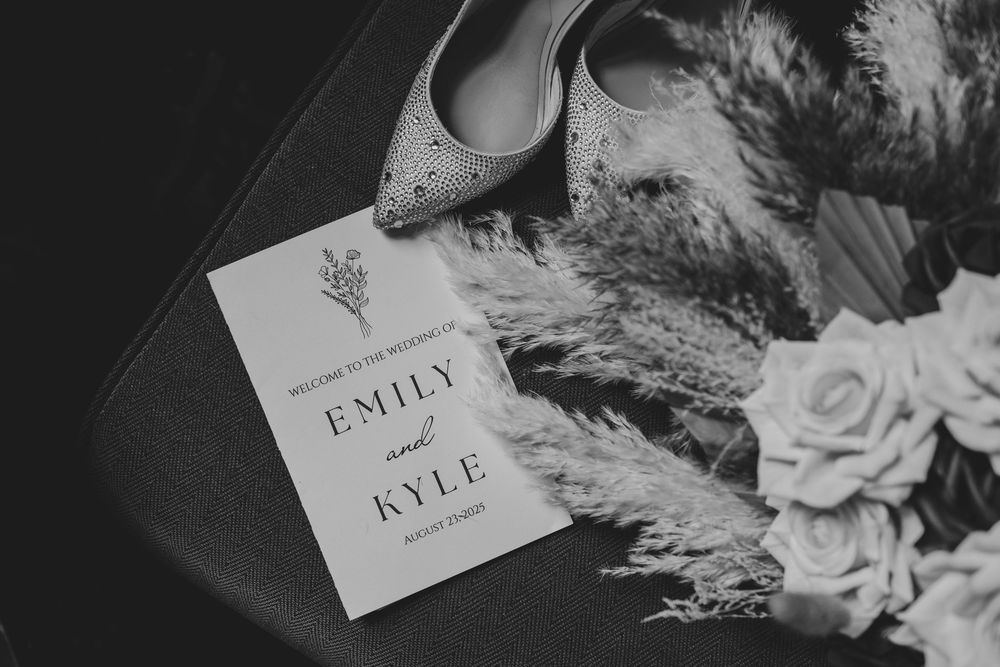 Black and white photo of elegant wedding name cards with floral decorative elements.