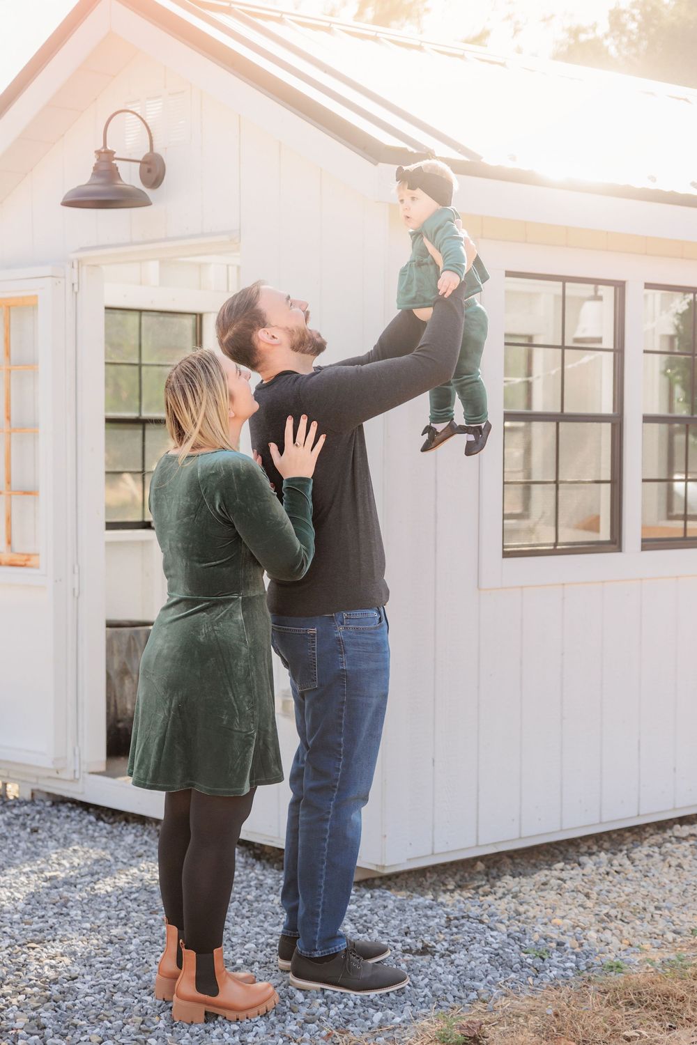 a family dancing with a white barn wall in the background at Turkey Trac Farm in Millville NJ