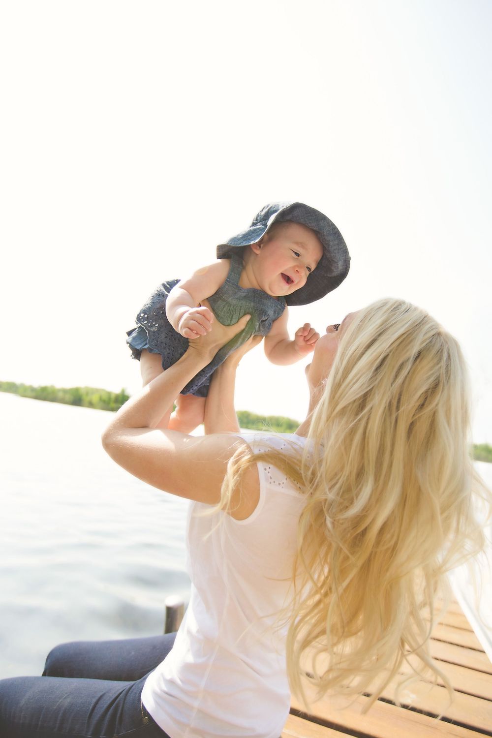 Mom and daughter swinging; family portrait session in South Lyon, Michigan.