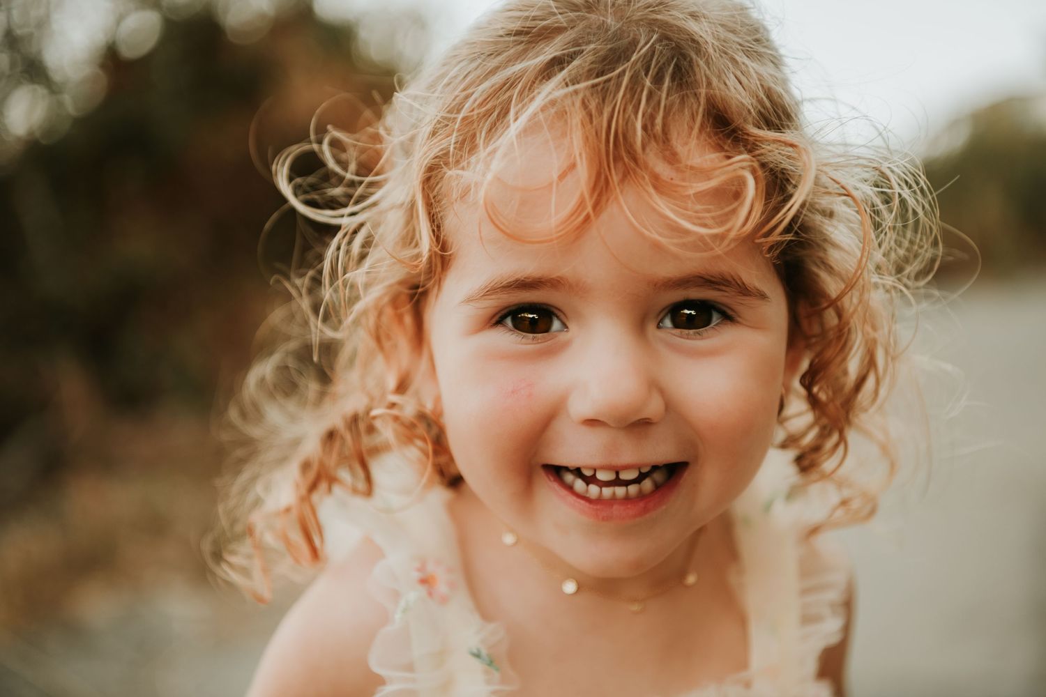 Close up portrait shots showing natural expressions and curly hair.