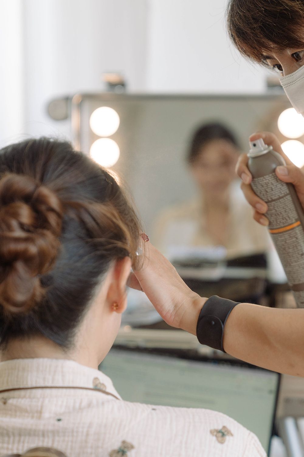 Hair styling session in progress with professional tools and equipment in a bright salon setting.