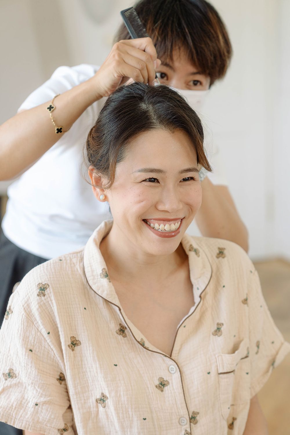 Getting ready scene during a hair styling session in a bright, modern setting.