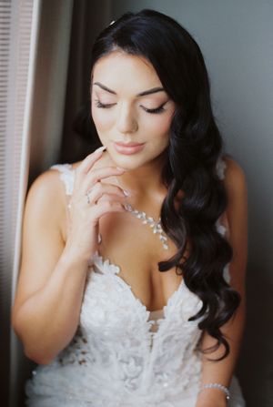 A sequence of four portraits showing someone in a white lace wedding dress with dark hair looking down thoughtfully.