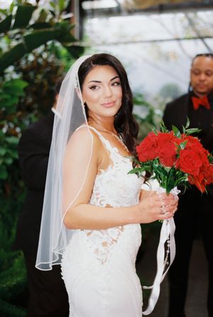 Sequence of bridal portraits showcasing a white lace gown and red rose bouquet.
