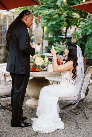A candid wedding moment captured at an outdoor reception with elegant table settings.