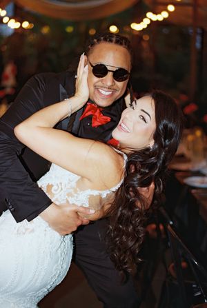 Romantic dance sequence of newlyweds with bride in white dress and groom in sunglasses.
